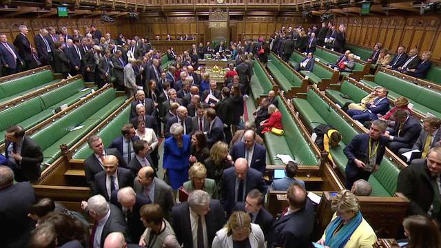 MP's leave the chamber to vote on a motion of no confidence after Parliament rejected Prime Minister Theresa May's Brexit deal, in London