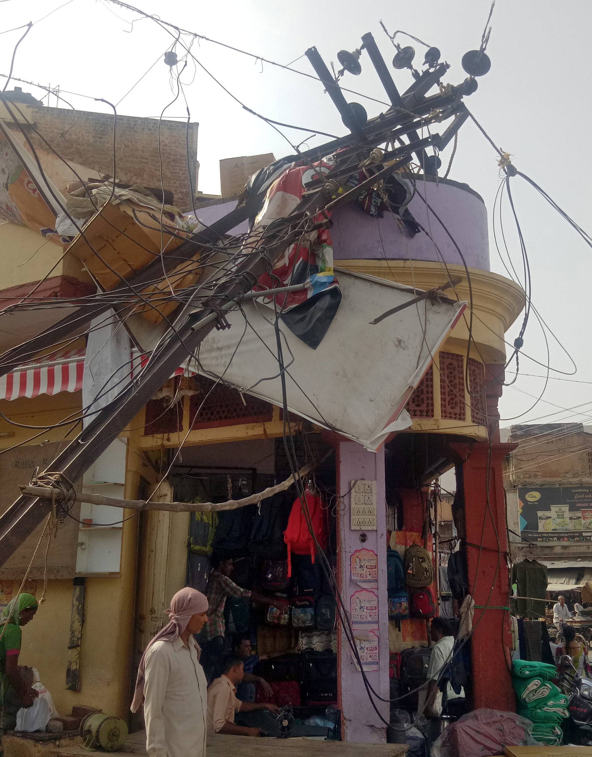 A damaged electric pole is pictured in a market after strong winds and dust storm in Alwar