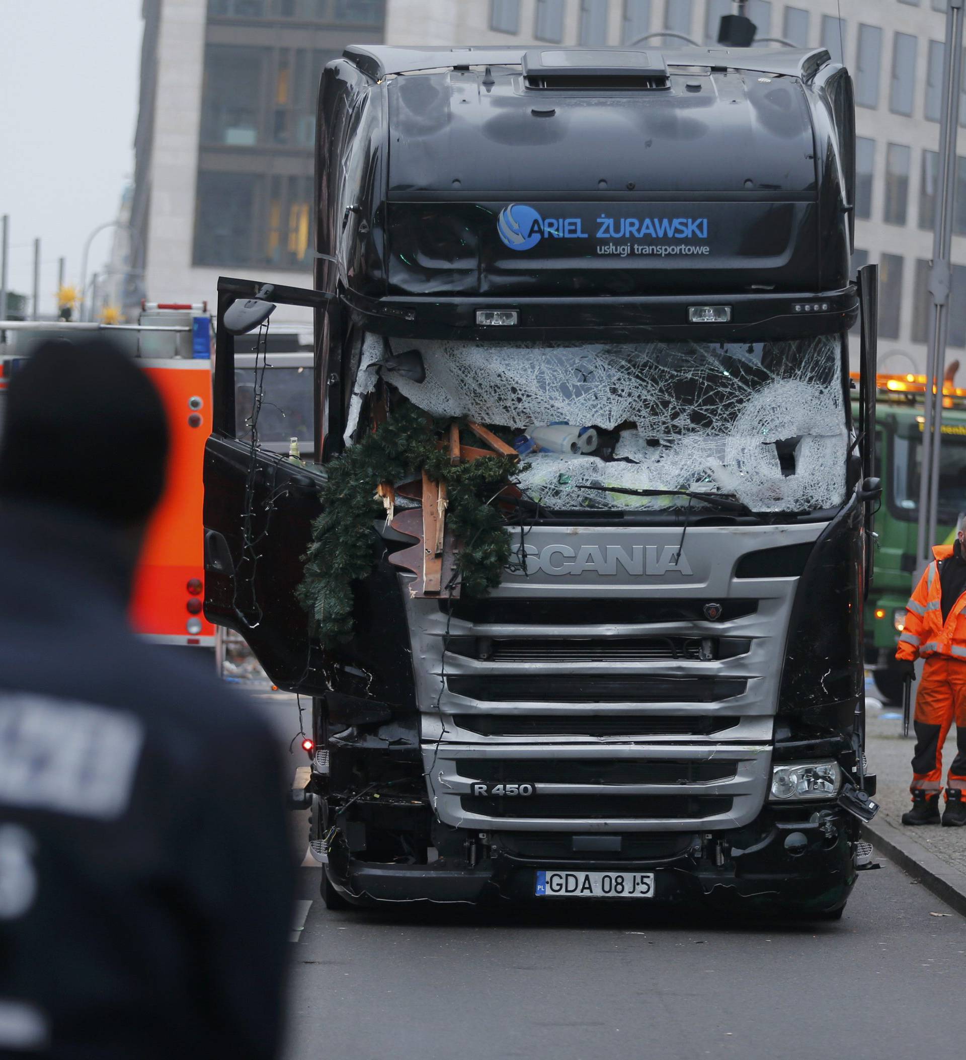 Police stand in front of the truck which ploughed last night into a crowded Christmas market in the German capital Berlin