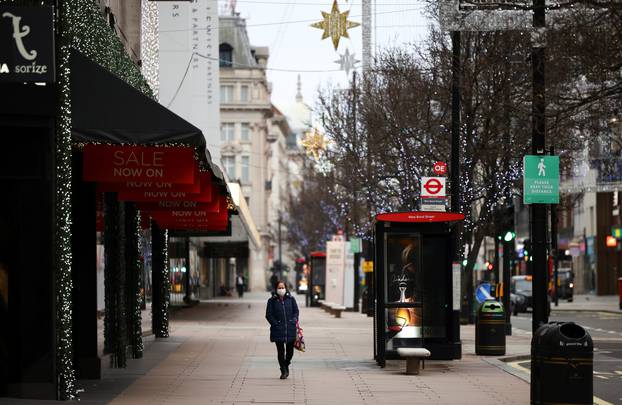 People walk along Oxford Street as shops remain closed under Tier 4 restrictions, amid the coronavirus disease (COVID-19) outbreak, in London