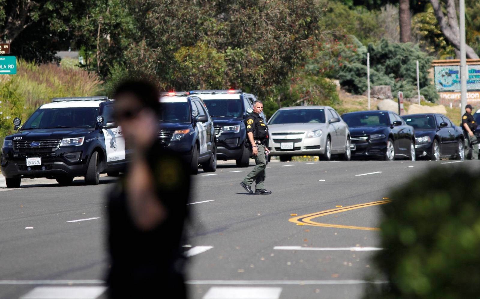 Police secure the scene of a shooting incident at the Congregation Chabad synagogue in Poway