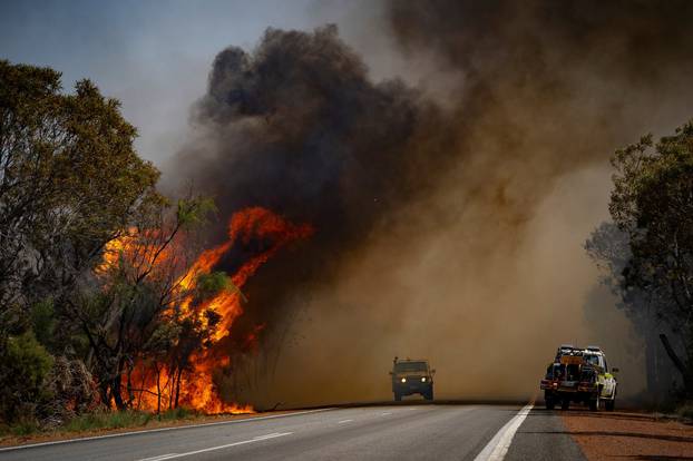 Firefighting vehicles are seen amid bushfire smoke in Red Gully, Western Australia