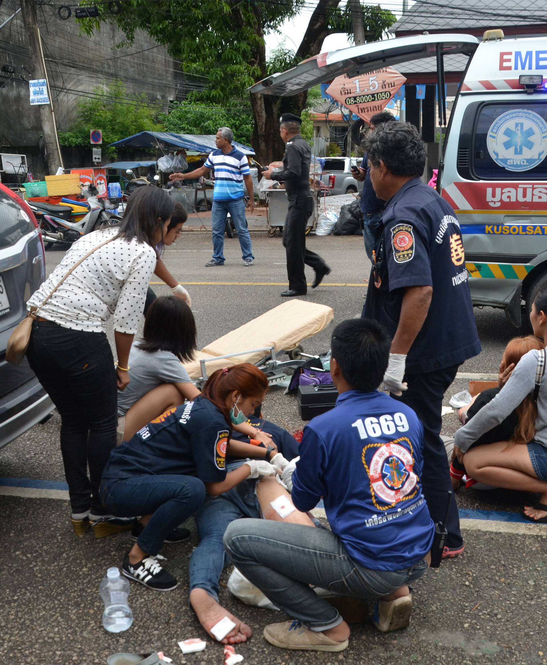 Injured people receive first aid after a bomb exploded on August 11, 2016 in Trang