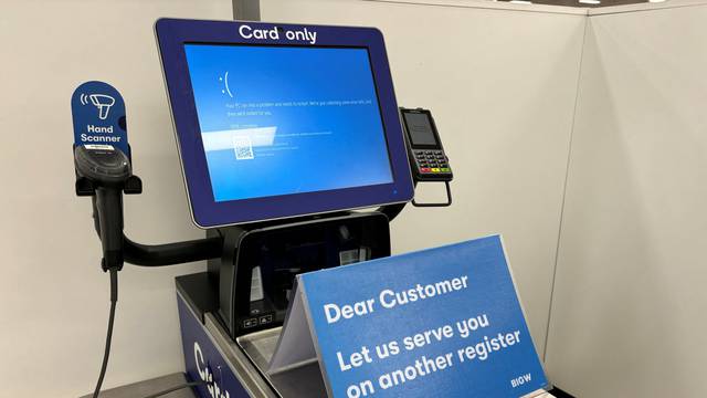 A blue error screen on a register is seen at a departmental store affected by cyber outage in Brisbane