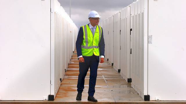 South Australian Premier, Jay Weatherill walks around the compound housing the Hornsdale Power Reserve, featuring the world's largest lithium ion battery made by Tesla, during the official launch near the South Australian town of Jamestown
