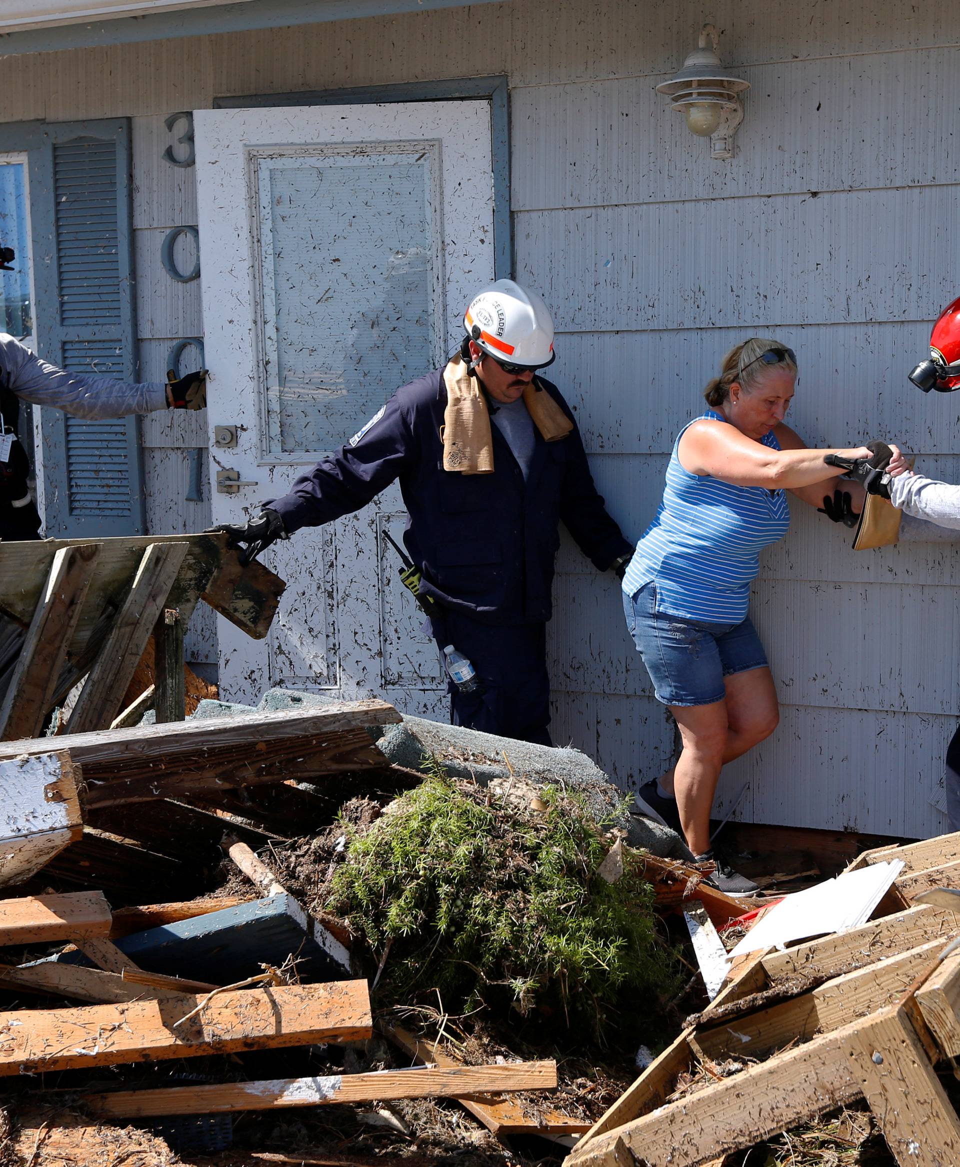 Bianna Kelsay is rescued from a building damaged by Hurricane Michael in Mexico Beach