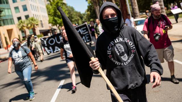 Anti-fascist counter-protestor parade through Sacramento after multiple people were stabbed during a clash between neo-Nazis holding a permitted rally and counter-protestors on Sunday at the state capitol in Sacramento.