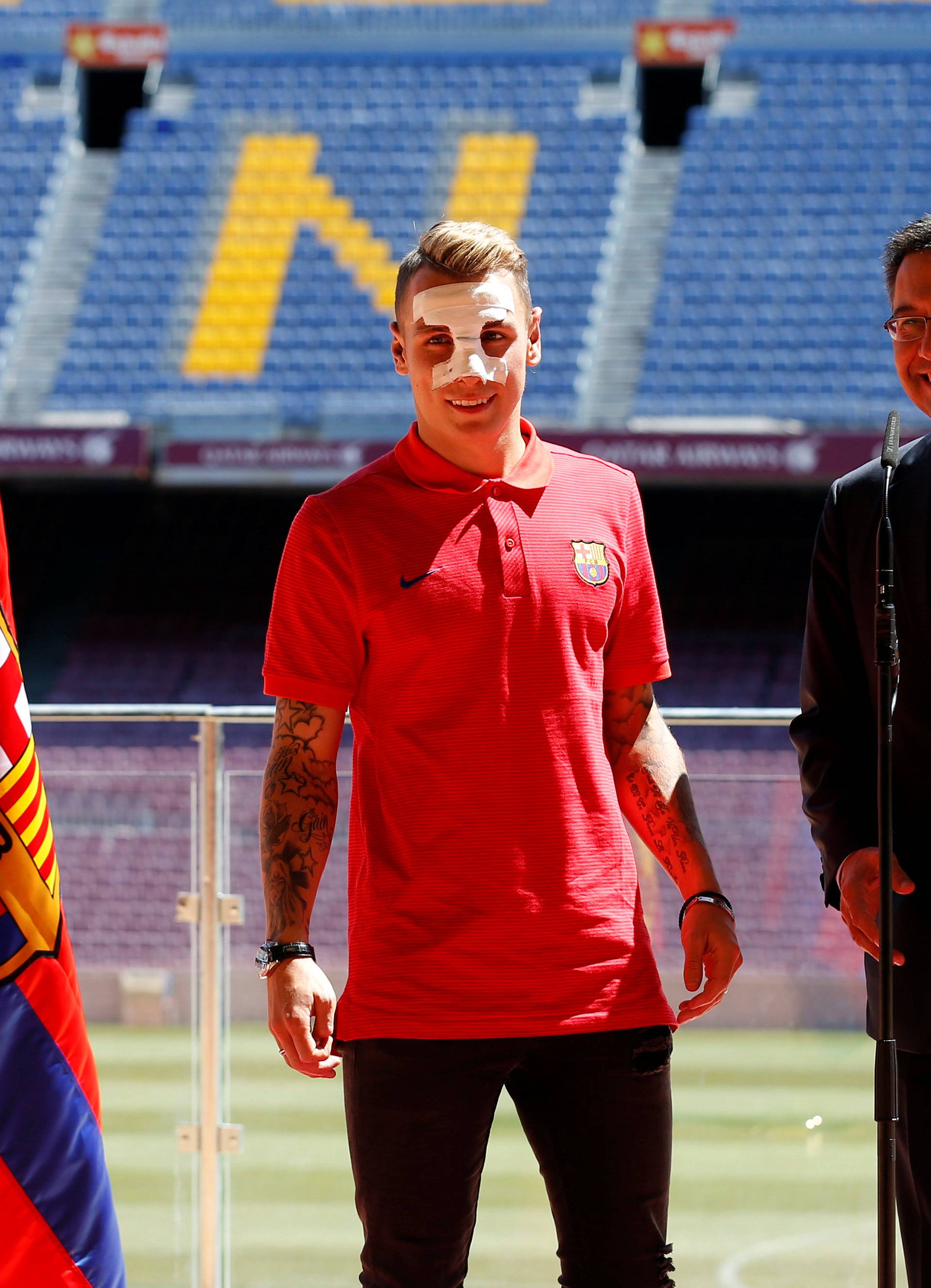 FC Barcelona's president Josep Maria Bartomeu poses with newly signed soccer player Lucas Digne during his presentation at Camp Nou stadium in Barcelona