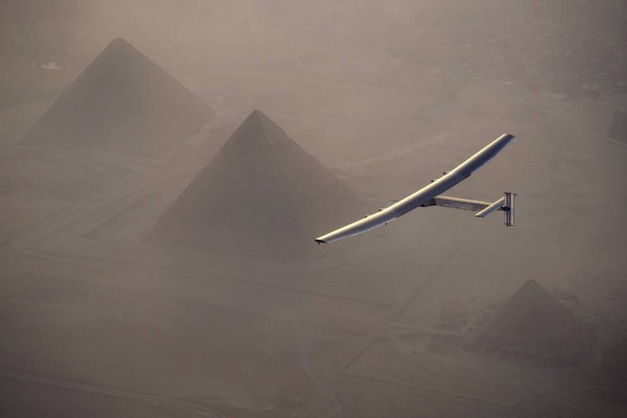 Solar Impulse 2, the solar powered plane, piloted by Swiss pioneer Andre Borschberg is seen during the flyover of the pyramids of Giza on July 13, 2016 prior to the landing in Cairo