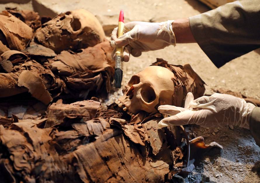 An Egyptian antiquities worker is seen in the recently discovered tomb of Amenemhat, a goldsmith from the New Kingdom, at the Draa Abu-el Naga necropolis near the Nile city of Luxor