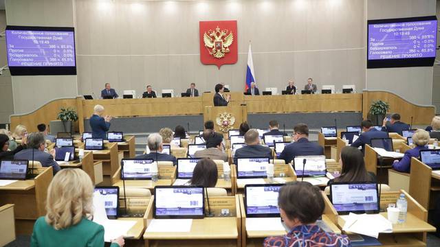 Russian parliamentarians vote for bill banning gender change surgery during a session of the State Duma in Moscow