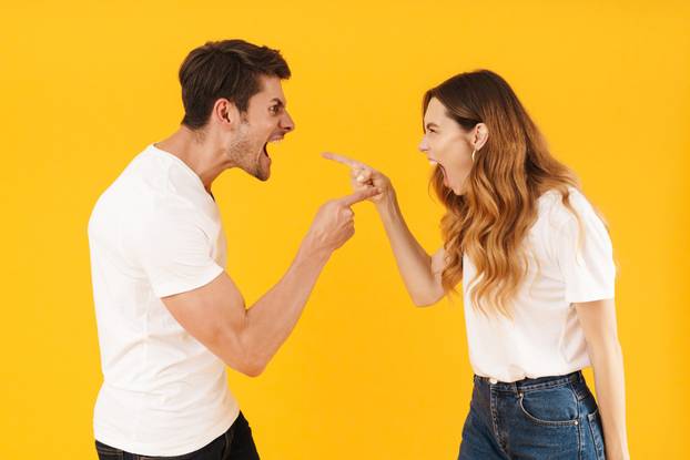 Photo of offended angry couple man and woman in basic t-shirts s