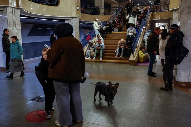 People take shelter inside a metro station during a Russian military attack, in Kyiv