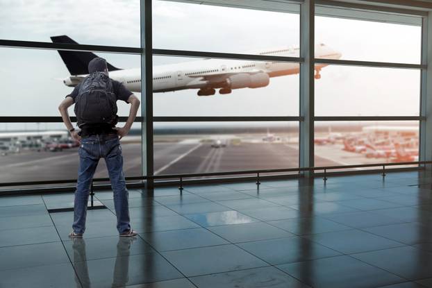 Backpack passenger in the airport terminal.