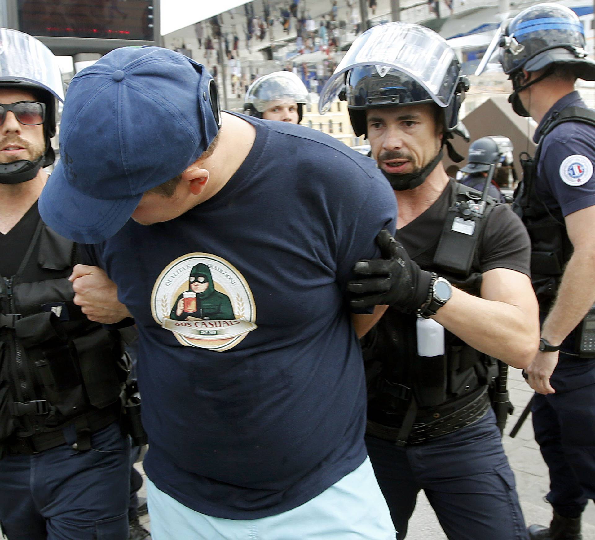 An England fan is detained by  riot police ahead of England's EURO 2016 match in Marseille