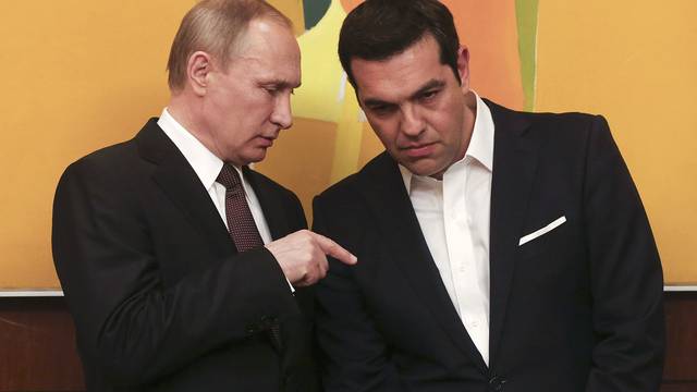 Greek PM Tsipras talks with Russian President Putin during their meeting in Athens