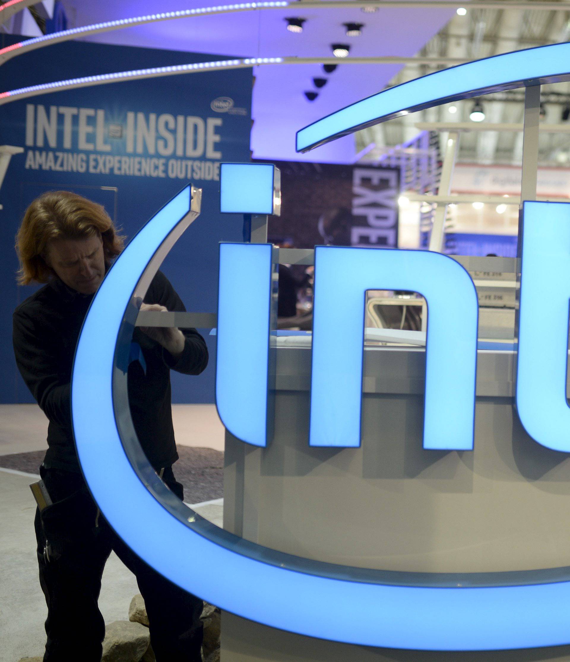 File photo of a worker arranging Intel logo at CeBIT trade fair in Hannover