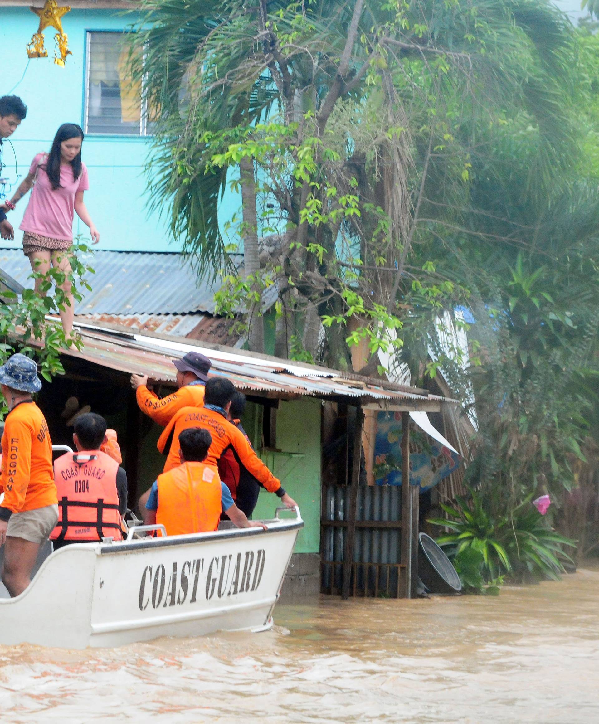 Rescuers evacute residents during heavy flooding in Cagayan de Oro city in the Philippines