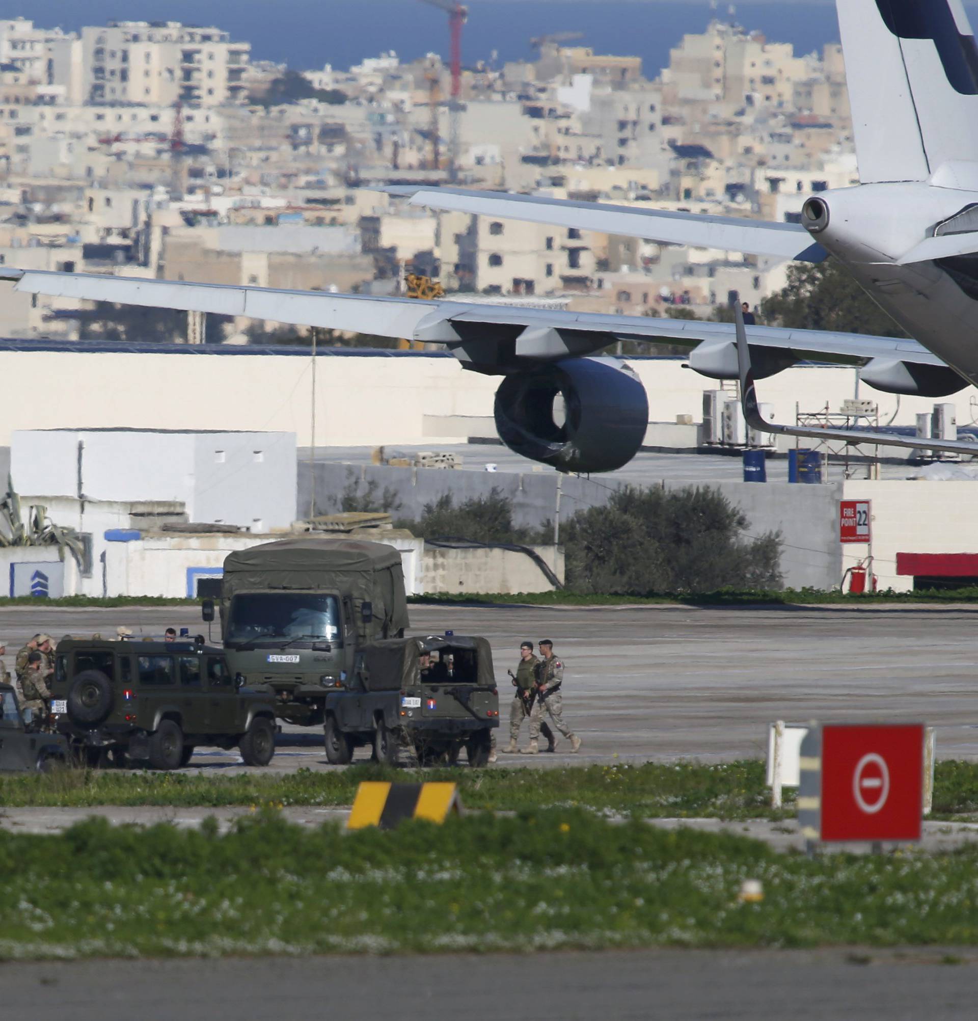 Maltese troops survey a hijacked Libyan Afriqiyah Airways Airbus A320 on the runway at Malta Airport