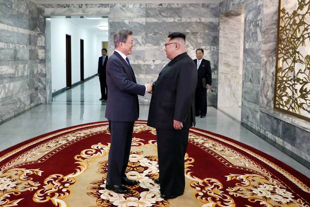 South Korean President Moon Jae-in shakes hands with North Korean leader Kim Jong Un during their summit at the truce village of Panmunjom