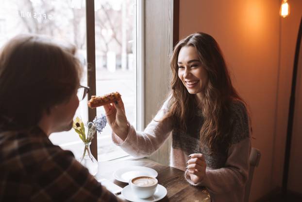 HAPPY COUPLE SITTING AT THE CAFE
