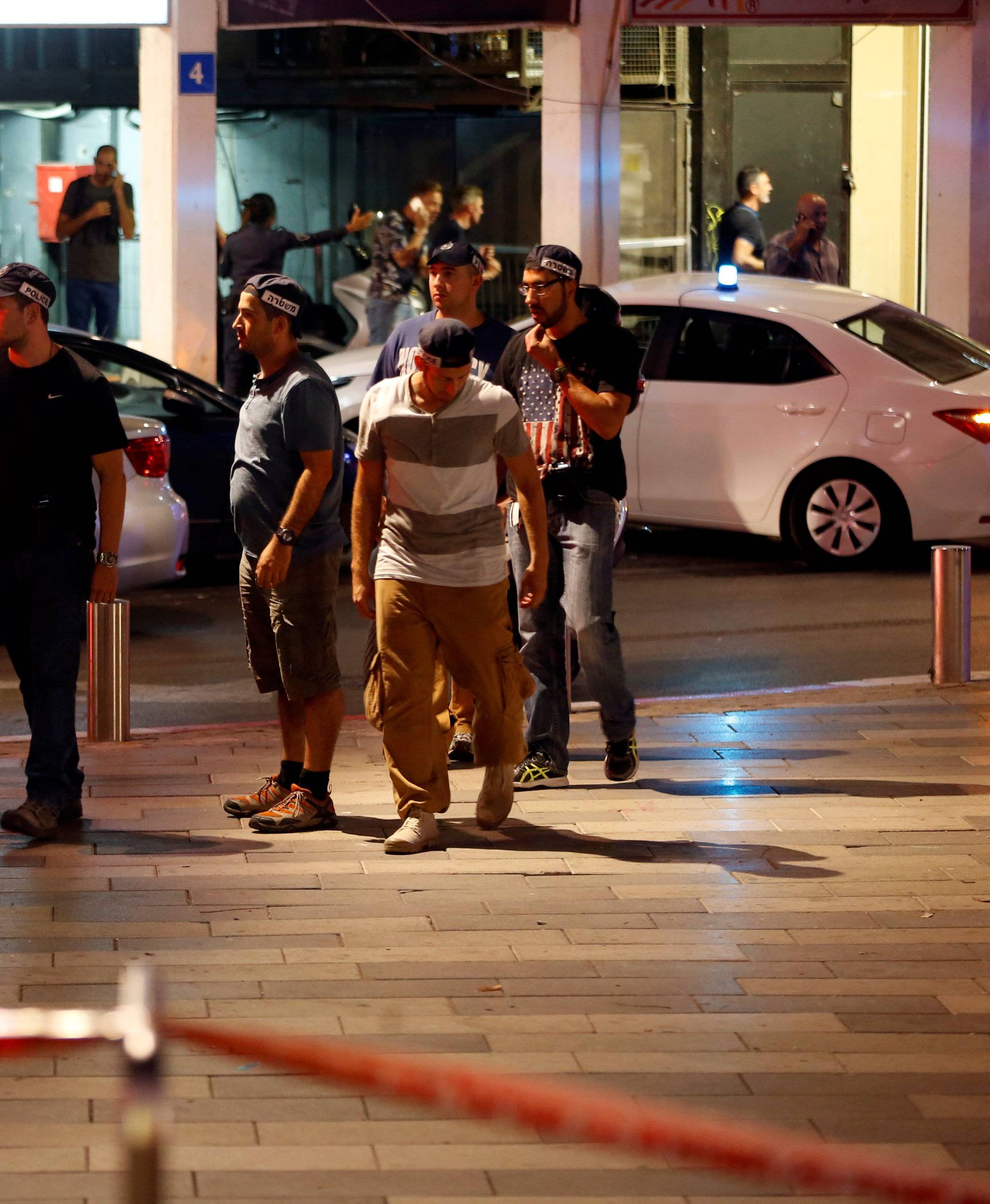 Israeli security personnel secure the area where a shooting attack took place in the center of Tel Aviv