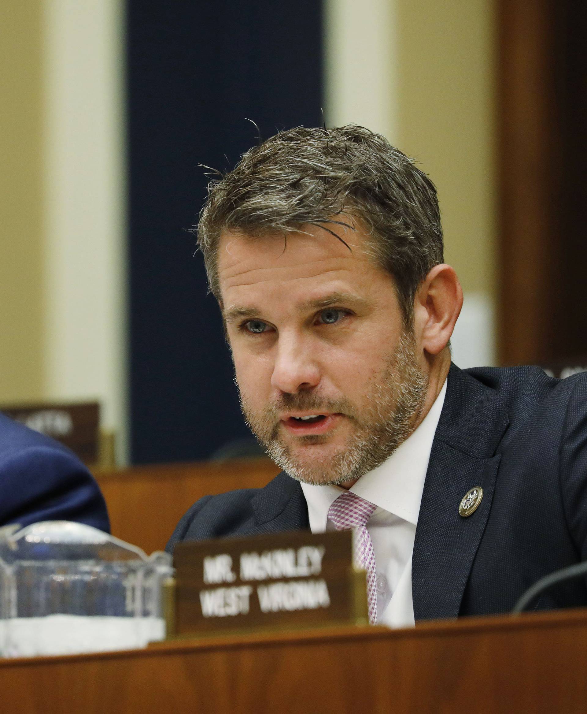 Rep. Kinzinger holds up his phone displaying a fake Facebook profile as Facebook CEO Zuckerberg testifies before the House Energy and Commerce Committee on Capitol Hill in Washington
