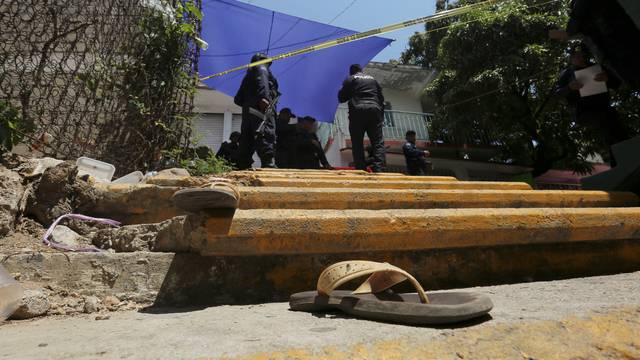 A pair of sandals are pictured near a crime scene after a shooting near a Via Crucis representation in Acapulco