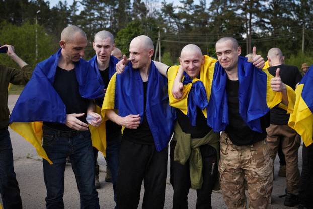Ukrainian POWs are seen after a swap at an unknown location in Ukraine