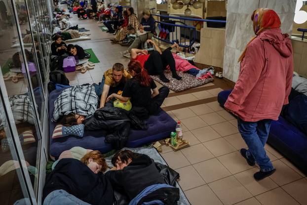 People take shelter inside a metro station during a Russian missile and drone attack in Kyiv
