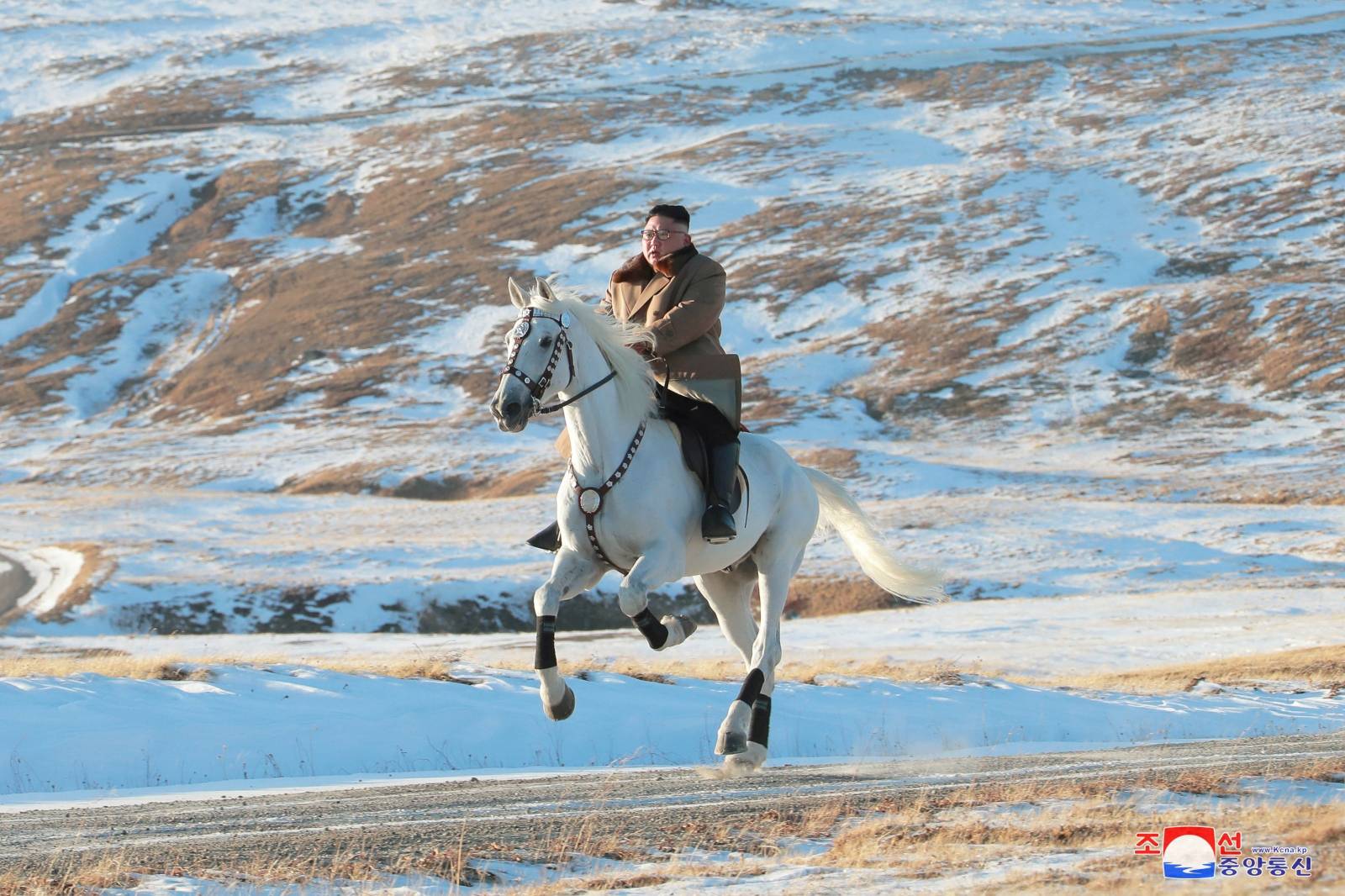 North Korean leader Kim Jong Un rides a horse during snowfall in Mount Paektu