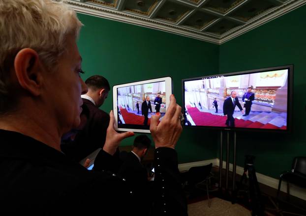 A journalist watches a ceremony to inaugurate Vladimir Putin as President of Russia at a press centre in Moscow