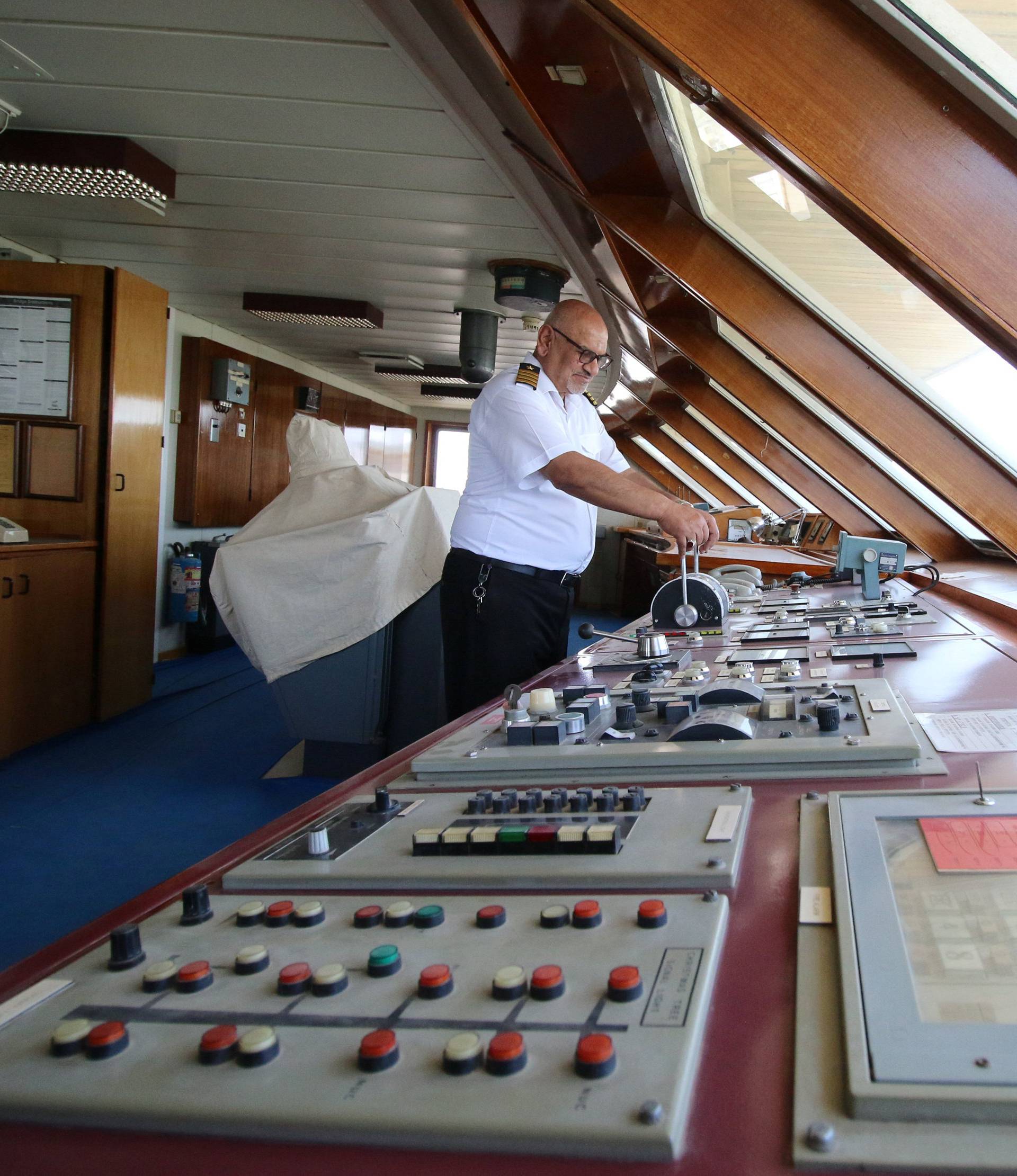 A captain inspects the yacht called "Basrah Breeze", once owned by a former Iraqi president Saddam Hussein, who was toppled in a U.S.-led invasion in 2003, in the southern port of Basra