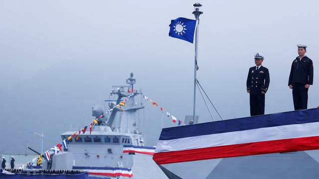 Navy personnel stand guard during the delivery ceremony of six made-in-Taiwan Tuo Chiang-class corvettes at a port in Yilan