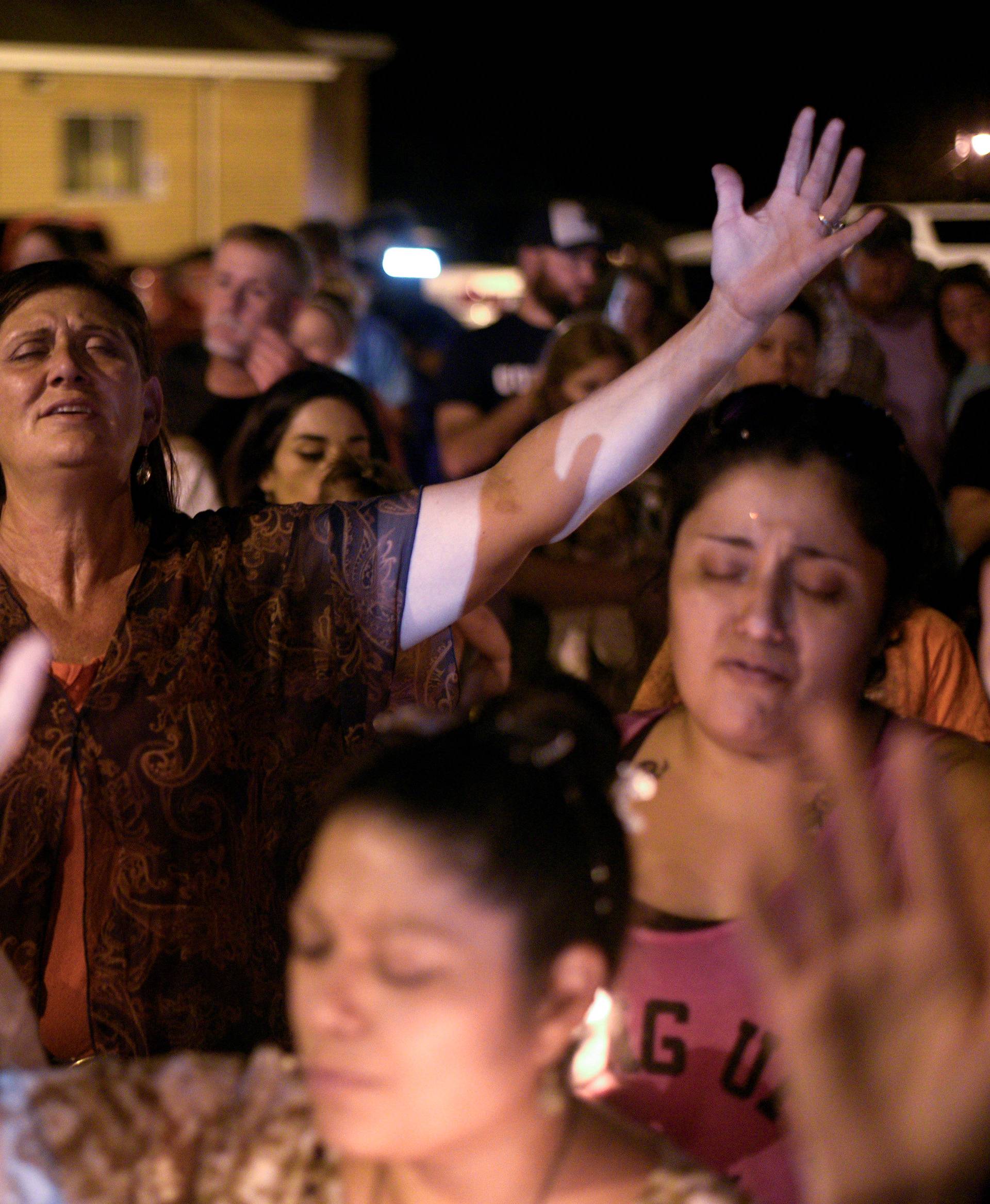 Mourners attend a candle light vigil after a mass shooting at the First Baptist Church in Sutherland Springs