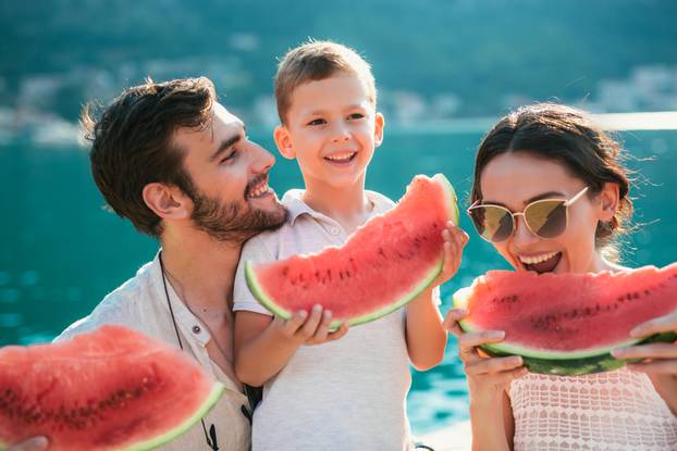 Family,Eating,Watermelon.,Little,Boy,And,His,Parents,On,The
