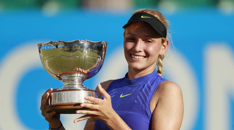 Croatia's Donna Vekic celebrates winning the final with the trophy
