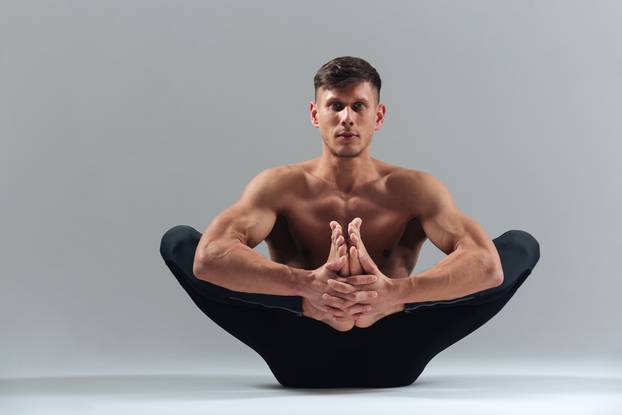 Handsome man doing yoga pose