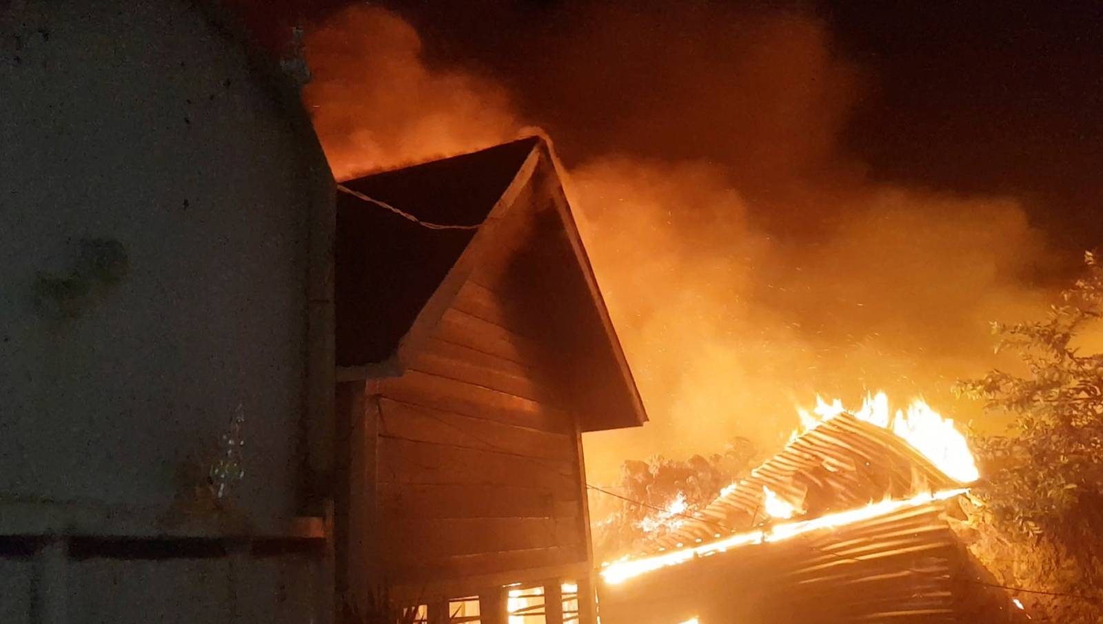 A building burns nears houses after the volcanic eruption of Mount Nyiragongo, in Goma