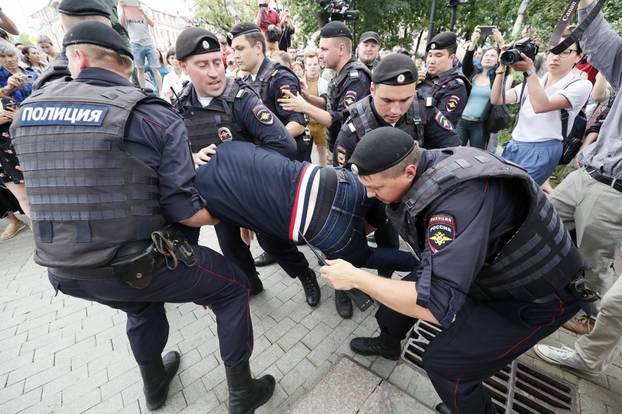 Law enforcement officers detain a participant of a rally in support of Russian investigative journalist Ivan Golunov in Moscow