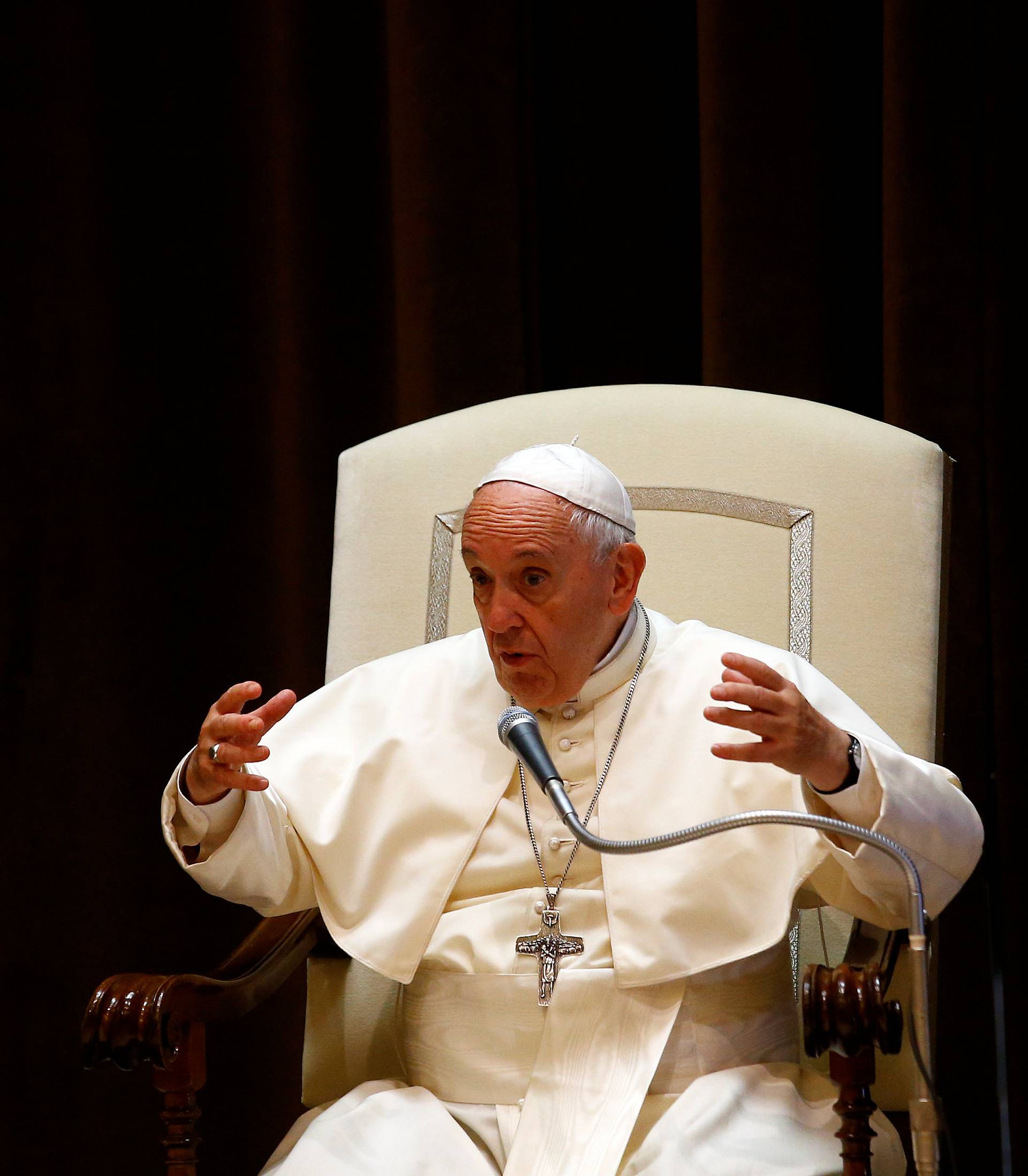 Pope Francis gestures during a meeting with children at the Vatican