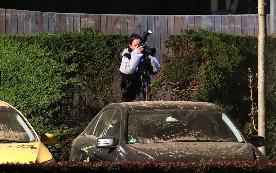 Forensic experts search the area where the expolsion occured