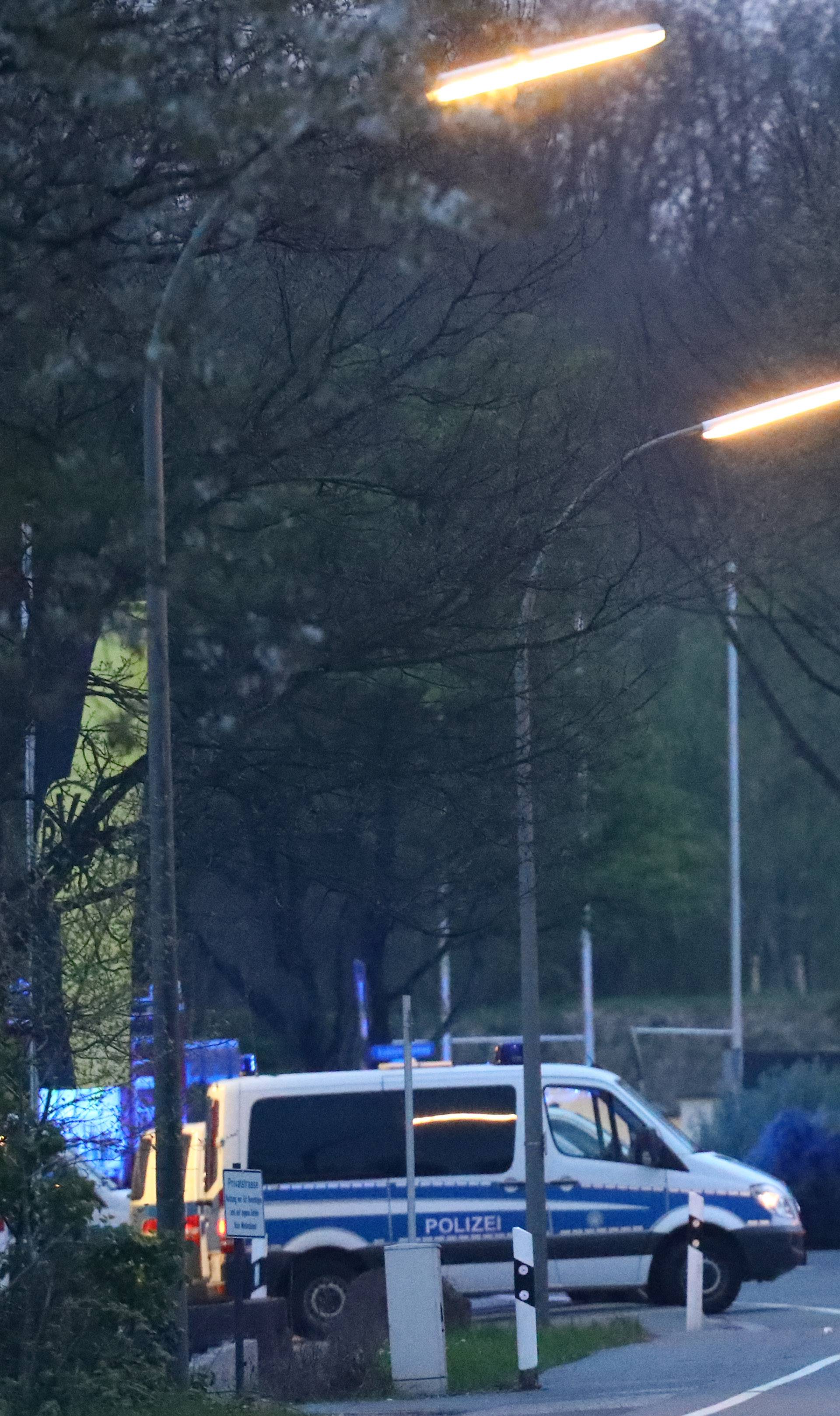 Police and emergency vehicles are seen near the Borussia Dortmund team hotel after an explosion before the game