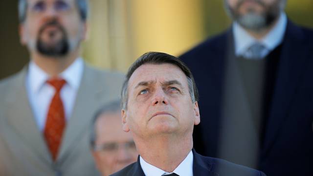 Brazil's President Bolsonaro attends a ceremony of hoisting the national flag in front the Planalto Palace in Brasilia