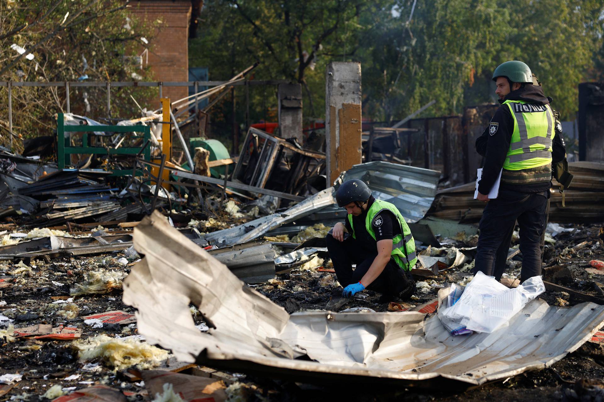 Firefighters work at a site damaged during a Russian missile strike, in Kyiv