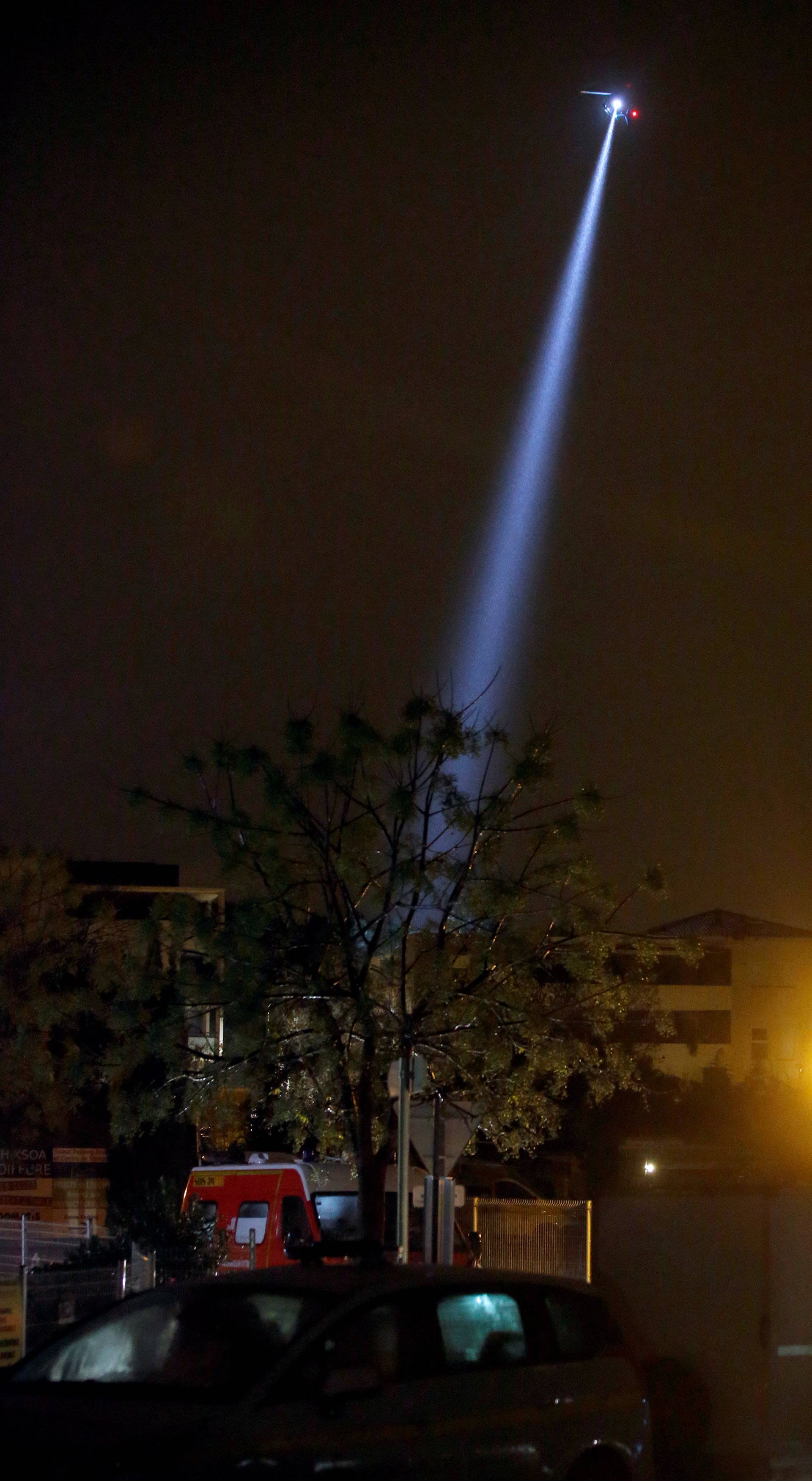 French police helicopter searches for an armed man after finding a dead woman in a retirement home where some 60 missionaries are living, in Montferrier-sur-Lez near Montpellier