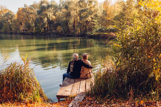 Senior,Family,Couple,Relaxing,By,Autumn,Lake.,Man,And,Woman