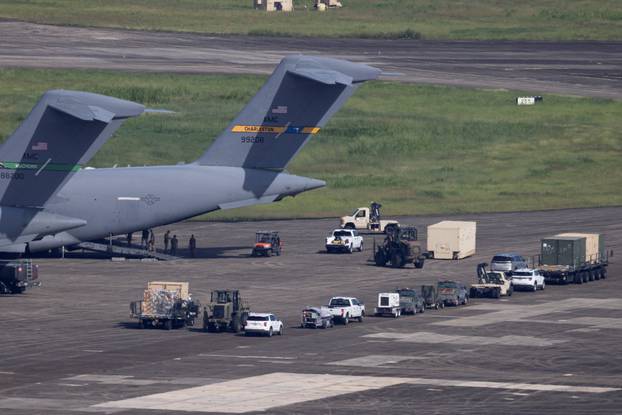 Ground crew members offload cargo from two U.S. Air Force C-17 Globemaster III aircraft at the former Roosevelt Roads Naval Station in Ceiba.