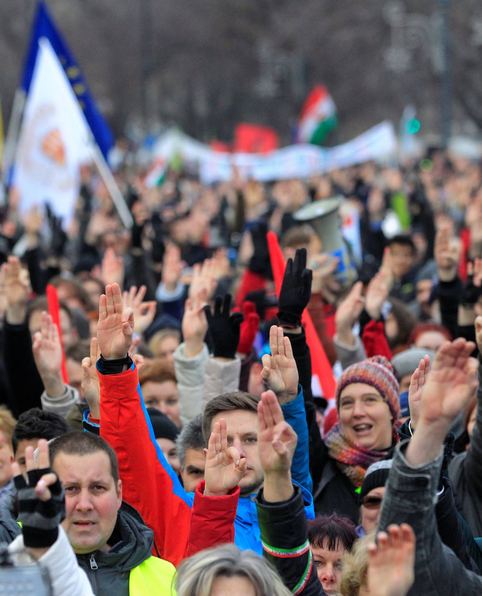 People take part in a protest against a proposed new labor law, billed as the "slave law", in Budapest