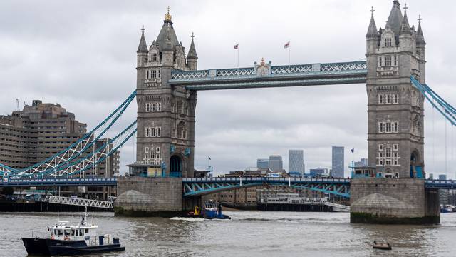 Police recover a body in the River Thames in London, UK.